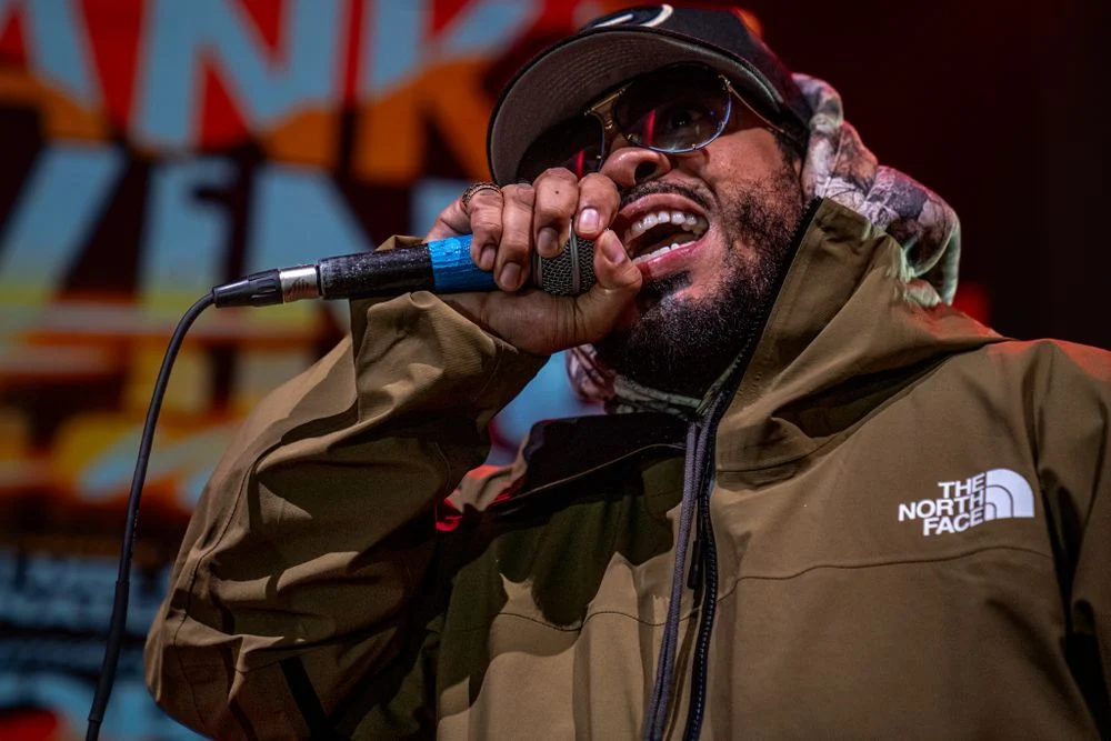 Rapper performing under dramatic stage lighting