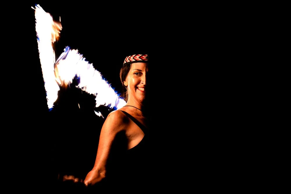 Fire performer smiling during a night performance