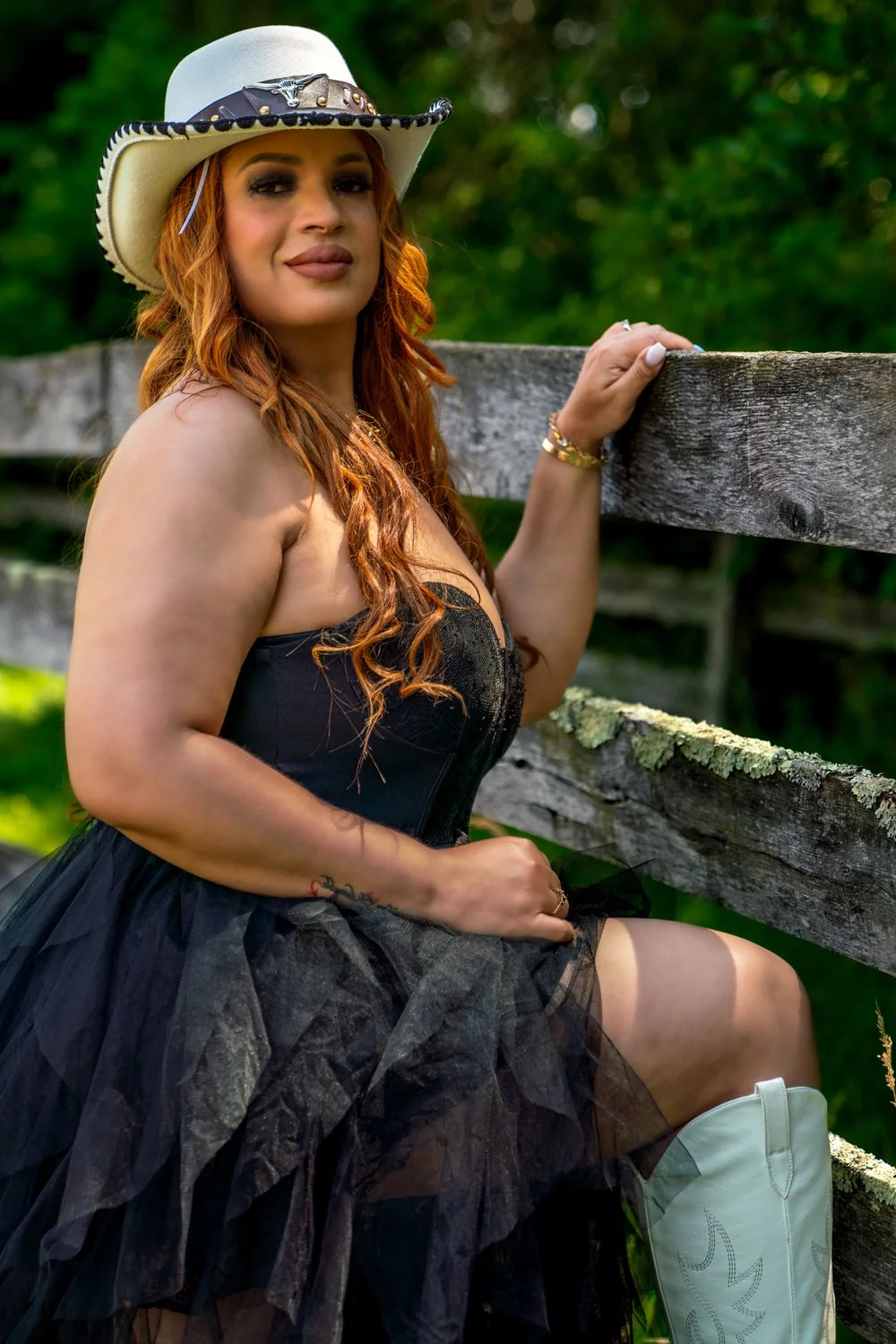 Outdoor portrait by a rustic fence