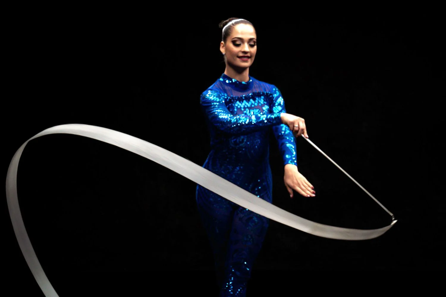 Performance portrait with ribbon against black