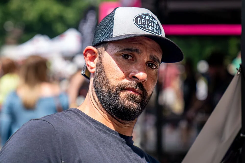 Candid portrait of a vendor at an outdoor event