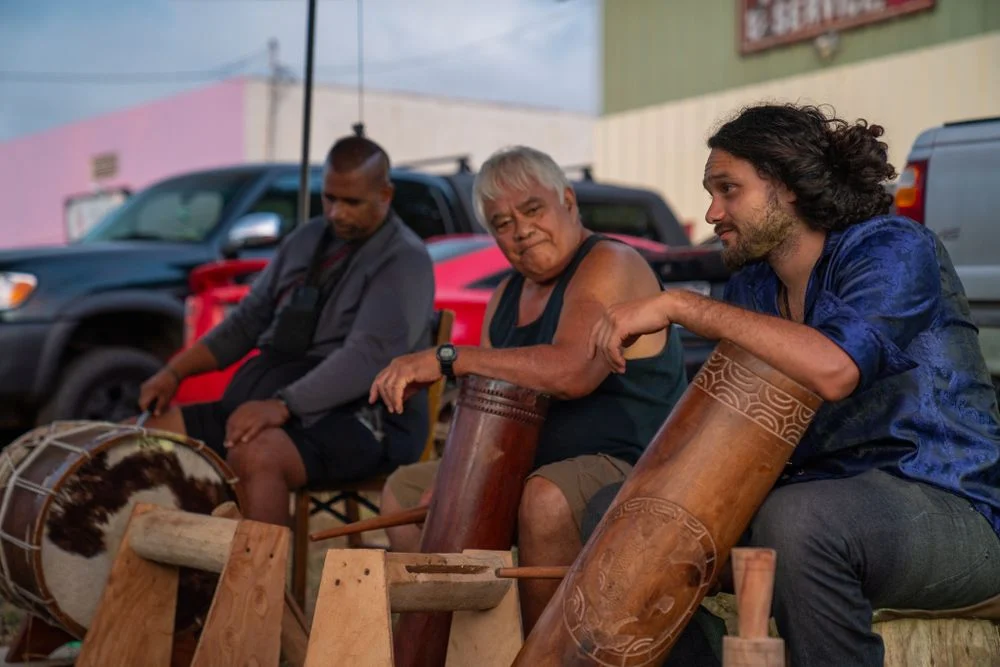 Local musicians play traditional instruments during an outdoor performance.