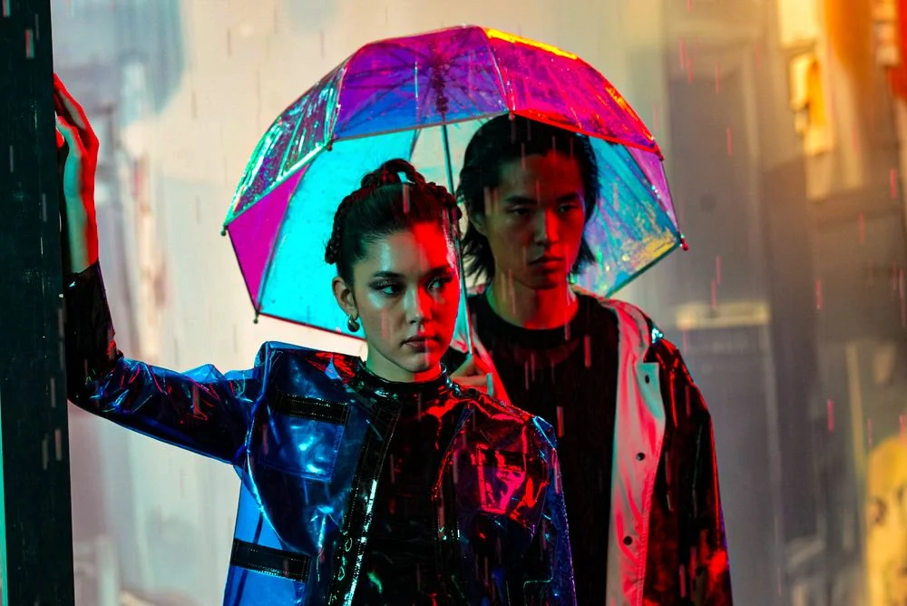Editorial duo portrait under red and cyan lighting