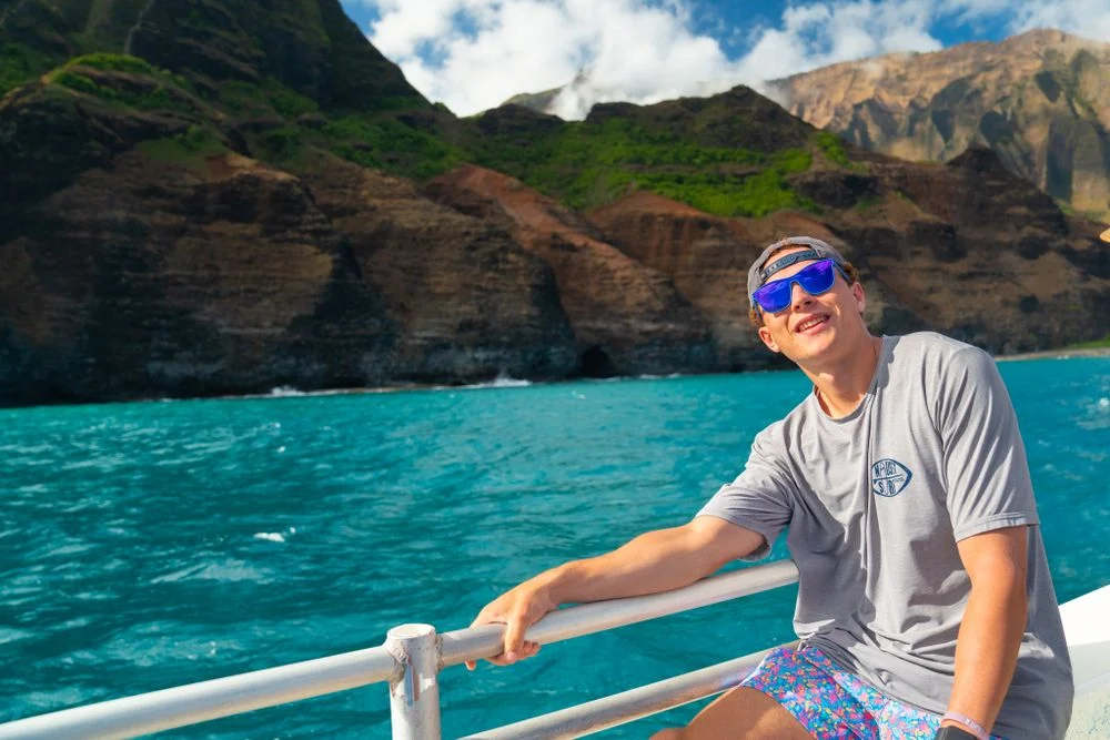 Traveler on a boat along a tropical coastline