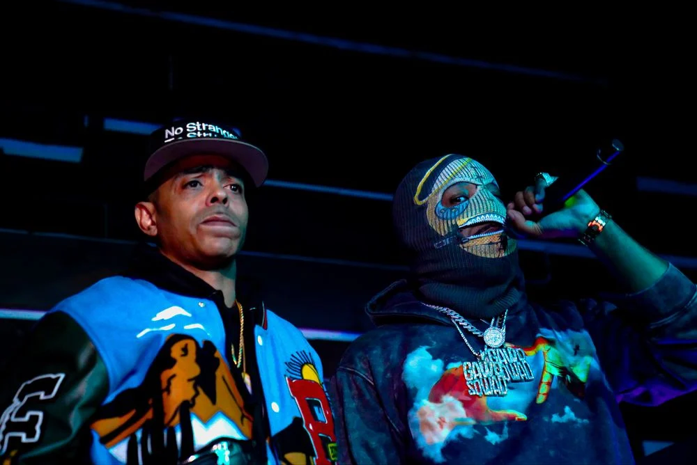 Two artists together during a live performance