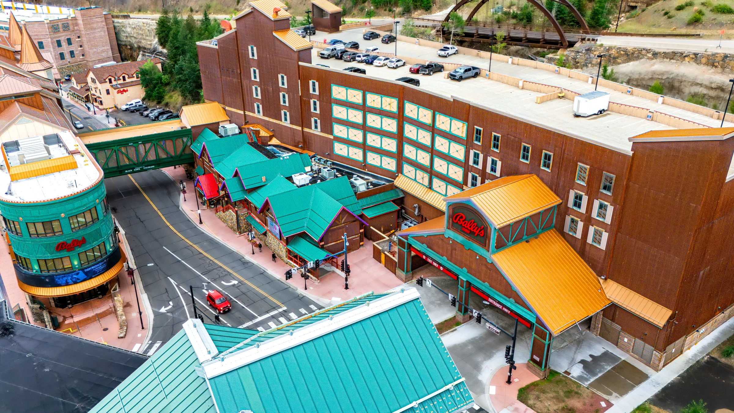 Aerial view of Bally's casino buildings, entrances, and colorful roofs in a mountain town.