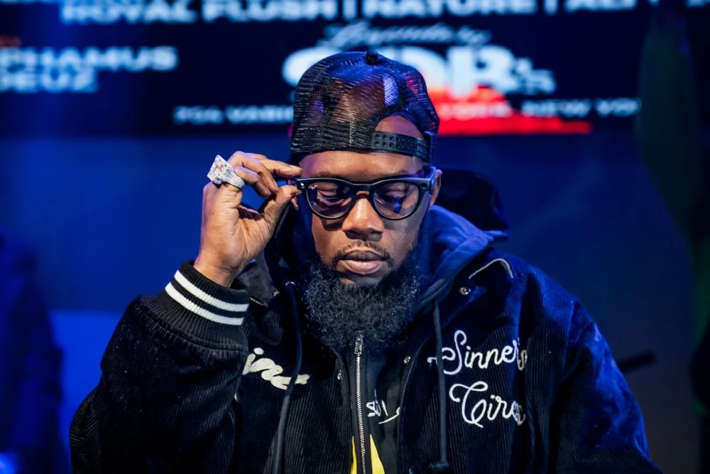Artist adjusting glasses between live performance moments