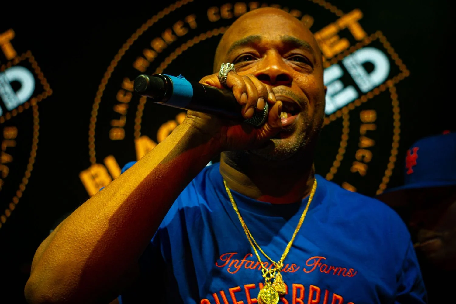 Close-up live performance portrait of a rapper