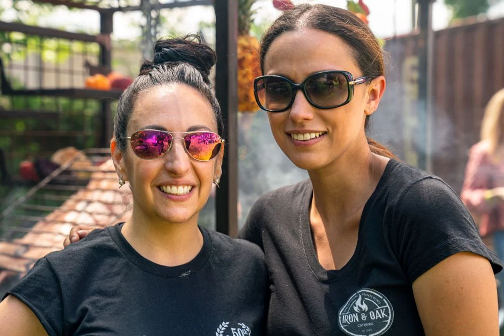 Two event staff members posing together