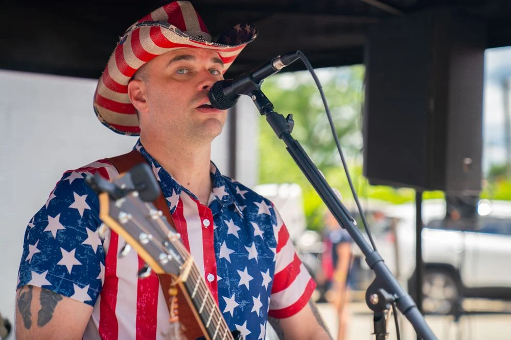Live musician performing at an outdoor community event