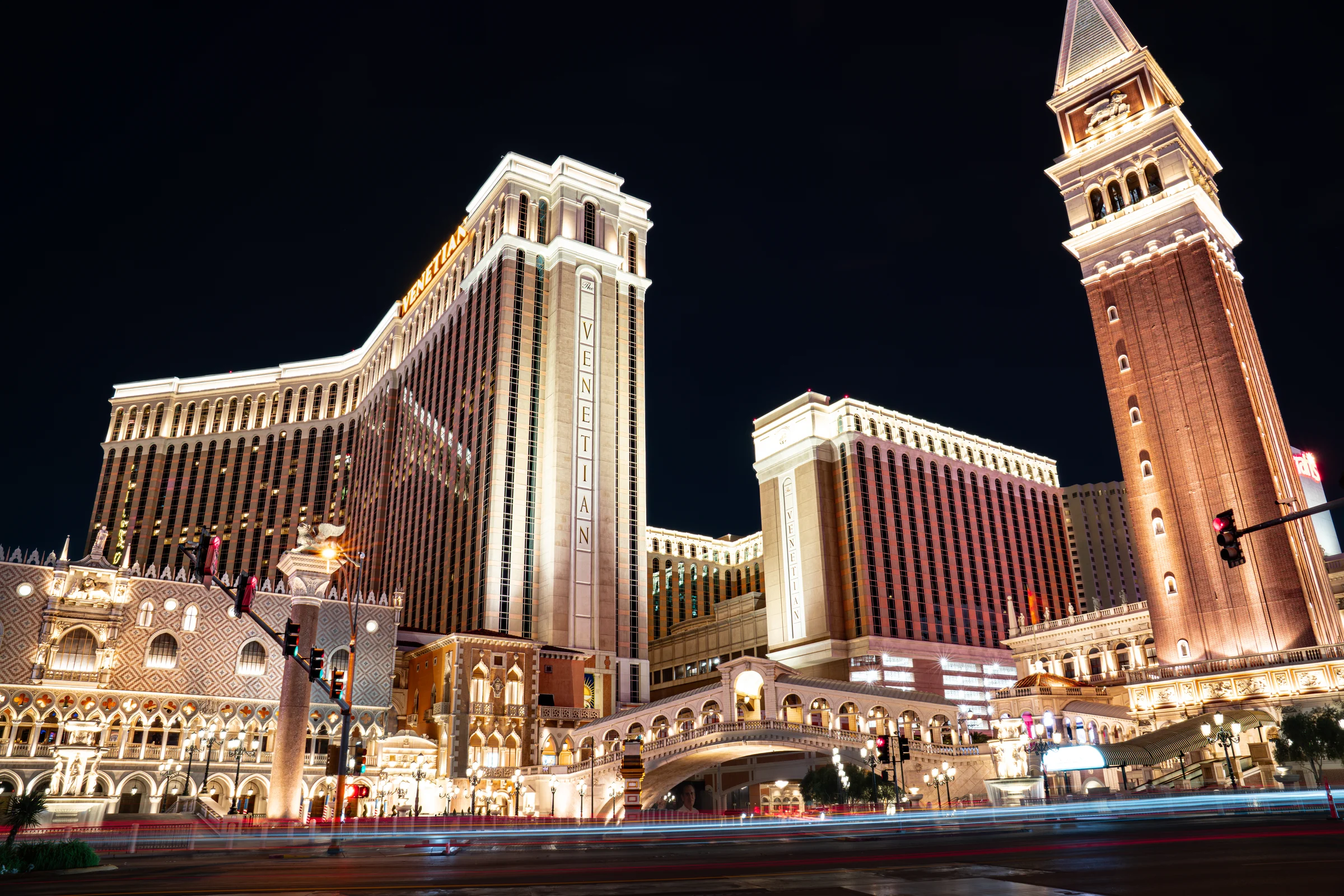 The Venetian resort and campanile glow above Las Vegas Boulevard at night.