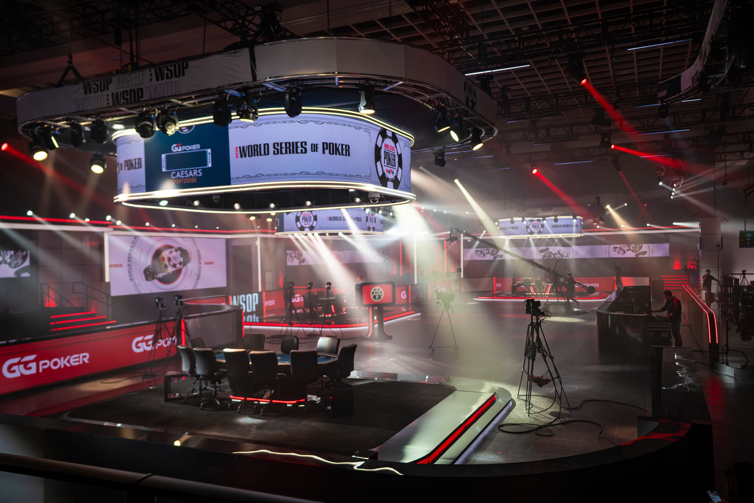 Spotlights cut through haze around an empty World Series of Poker broadcast stage.